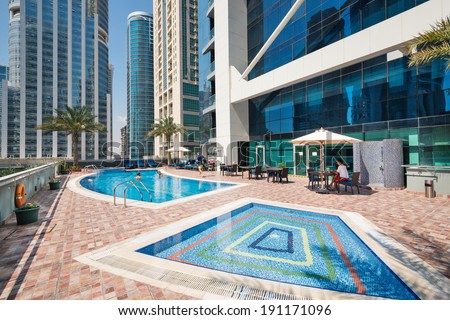 DUBAI, UAE - MARCH 28, 2014: Swimming pool of Indigo Tower. In Dubai there is a high concentration of swimming pools due to climate conditions and the high pro capital income.