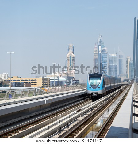 DUBAI, UAE - MARCH 28, 2014: Train approaching Jumeirah Lakes Tower metro station. The JLT is a large development which consists of 79 towers being constructed along the edges of 4 artificial lakes.