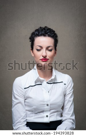 Business woman portrait with closed eyes on grunge background.