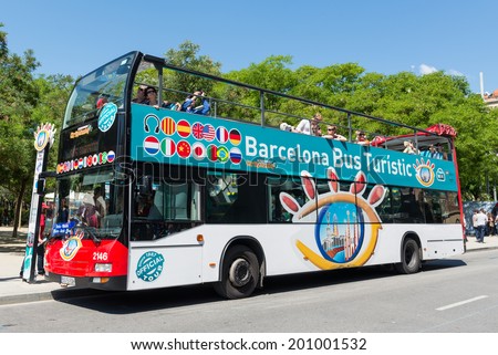 BARCELONA, SPAIN - JUNE 1, 2014: Touristic bus in front of Sagrada Familia. Barcelona City Tour is a new official touristic bus service that shows the city with an audio guide.