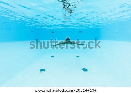 Underwater man inside swimming pool.