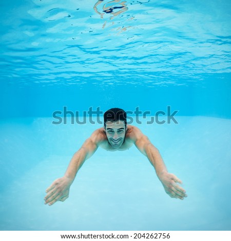 Underwater man inside swimming pool after dipping.
