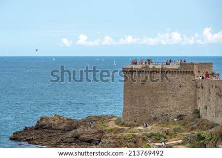 SAINT MALO, FRANCE - AUGUST 4, 2014: Tourists visiting the city. Saint-Malo is a walled port city in Brittany in northwestern France on English Channel.