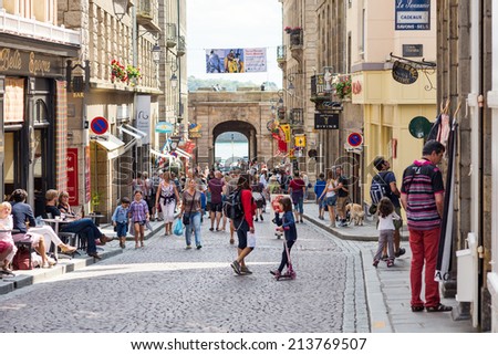 SAINT MALO, FRANCE - AUGUST 4, 2014: People walking inside the city. Saint-Malo is a walled port city in Brittany in northwestern France on English Channel.