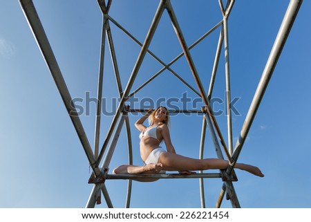 Beautiful woman gymnast portrait outdoors in a park.