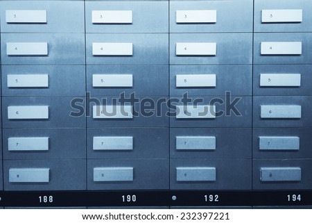 Safe deposit boxes in a bank vault. Blue tone image.
