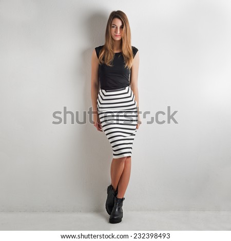 Fashion woman portrait against white wall background.