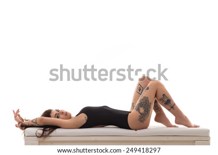 Woman portrait with tattoo against white background.