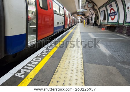 LONDON - APRIL 12, 2013: Mind the Gap sign in Kennington Station. The Underground system serves 270 stations and has 402 kilometres (250 mi) of track, 45 per cent of which is underground.