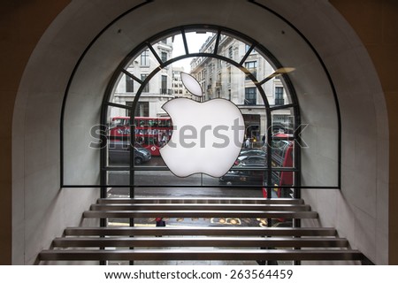 LONDON - APRIL 12, 2013: Apple logo displayed on window of Apple Store. As of 2014, Apple employs 72,800 permanent full-time employees, maintains 437 retail stores in fifteen countries.