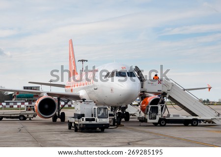BOLOGNA, ITALY - APRIL 5, 2015: Boarding Easy Jet airplane at Bologna airport. The airport is named after Bologna native G. Marconi, an Italian electrical engineer and Nobel laureate.