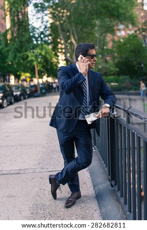 Businessman talking at the phone on the street. Manhattan, New York City.