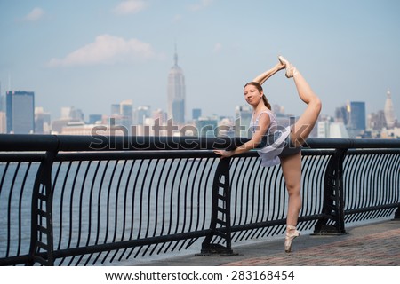 Young beautiful ballerina dancing along the New Jersey waterfront with New York skyline in the background. Ballerina Project.