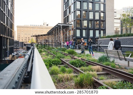 NEW YORK CITY - MAY 2015: People walking on the High Line Park. The High Line is a park built on an historic freight rail line elevated above the streets in the West Side.