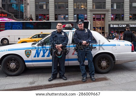 NEW YORK CITY - MAY 2015: NYPD Police Officers at Times Square. The New York City Police Department, established in 1845, is the largest municipal police force in the United States.