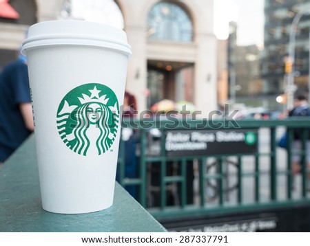 NEW YORK CITY - MAY, 2015: Starbucks Hot beverage coffee in front of Astor Place Store with blurred people in background walking. Starbucks is the largest coffeehouse company in the world.