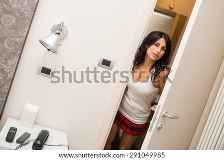 Portrait of sensual young woman in hotel room.