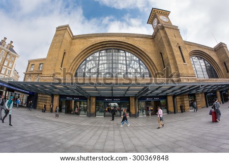 LONDON - JUNE 17, 2015: People walking in front of view of King\'s Cross railway station, a major London railway terminus which opened in 1852 on the northern edge of central London.