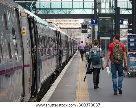 LONDON - JUNE 17, 2015: People walking inside King\'s Cross railway station, a major London railway terminus which opened in 1852 on the northern edge of central London.