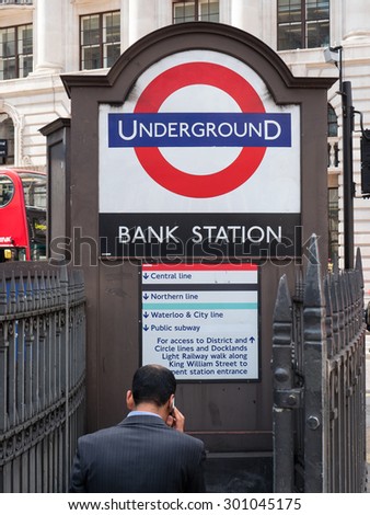 LONDON, UNITED KINGDOM - JUNE 18, 2015: Businessman entering Bank Station. The Underground system serves 270 stations and has 402 kilometres (250 mi) of track, 45 per cent of which is underground.