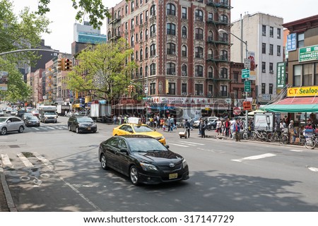 NEW YORK CITY - MAY 16, 2015: Chinatown busy intersection. Chinatown is a neighborhood in Manhattan that is home to the largest enclave of Chinese people in the Western Hemisphere.