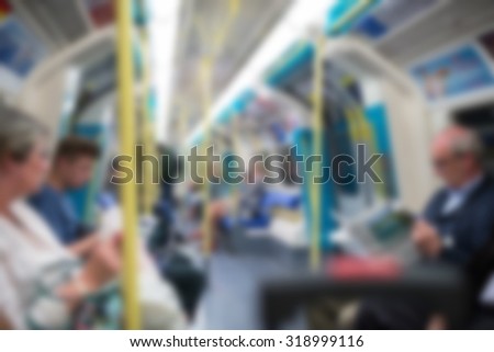 Blurred underground wagon with people. London, UK. Defocused image.