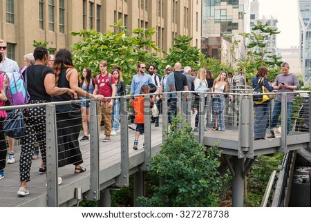 NEW YORK CITY - MAY 16, 2015: People relaxing on the High Line Park. The High Line is a park built on an historic freight rail line elevated above the streets in the West Side.