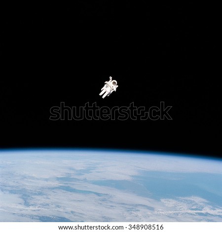 Astronaut space walking from Shuttle in outer space. Earth in the background. Elements of this image furnished by NASA.