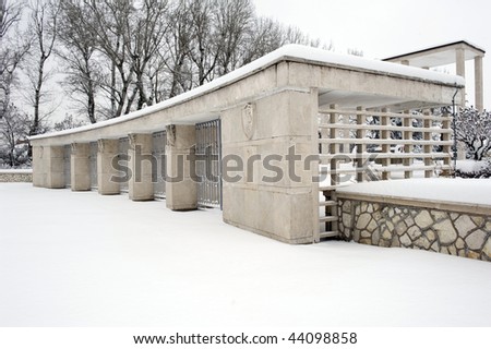 Main entrance of the War Pole cemetery covered by snow. San Lazzaro, Bologna, Italy.