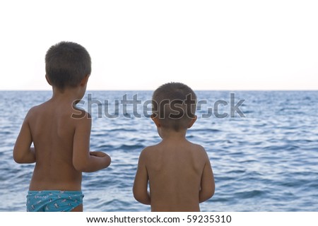 Two brothers playing on the beach.