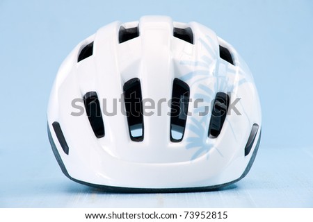 White bike helmet isolated on blue background. Front view.