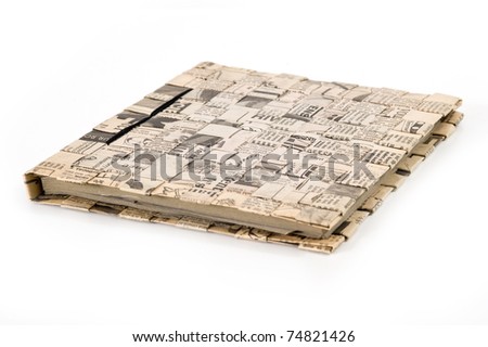 Diary book on white background. Cover made by old newspaper put together.