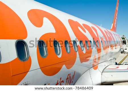 LONDON, UNITED KINGDOM - MAY 31: Boarding on Easy Jet airplane in Gatwick airport. Easy Jet is flying 48.8 million passengers with 125 airports in 29 countries. May 31, 2011 in London, United Kingdom.