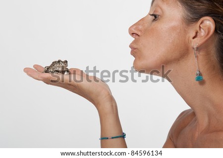 Frog prince kissed by a beautiful woman.