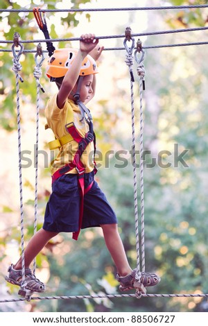 6 year old Kid climbing trees in Dolomites, Italy.