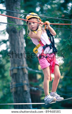 Young Girl climbing trees in Dolomites, Italy.