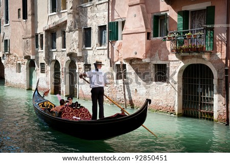 VENICE, ITALY - SEPTEMBER 31: Tourists on a Gondola, September 31, 2011 in Venice, Italy. The city has an average of 50,000 tourists a day and it\'s one of the world\'s most internationally visited city