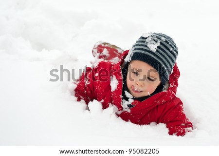 Young boy having fun in the snow.
