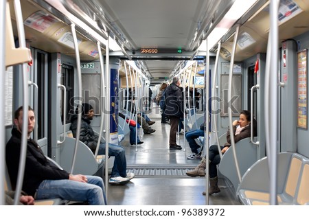 MILAN, ITALY - FEBRUARY 25: Commuters in subway wagon on February 25, 2012 in Milan, Italy. Milan underground is spread over three lines for a total of about 76 km long and 84 stations in operation.
