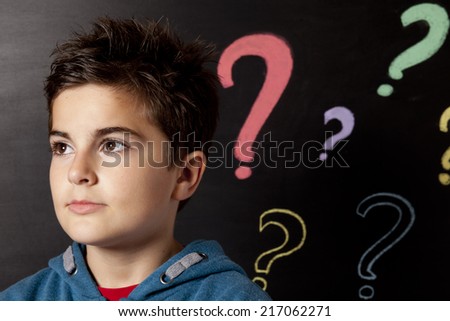 child and blackboard with questions mark