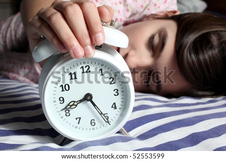 child and alarm clock in the morning