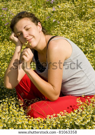 stock photo Young girl with a wedding ring in a chamomile field