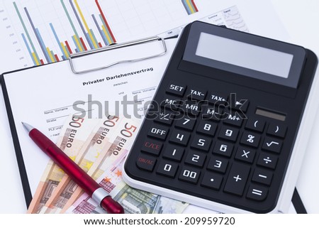 Private loan application form with calculator, money, pen and statistics report