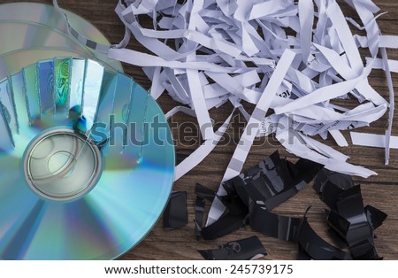 Image shows paper shavings, mag tape shred and compact disks