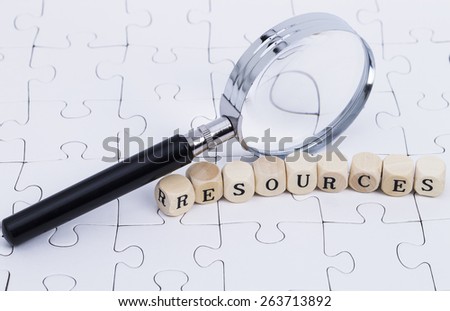 White puzzle with magnifier and letters \
