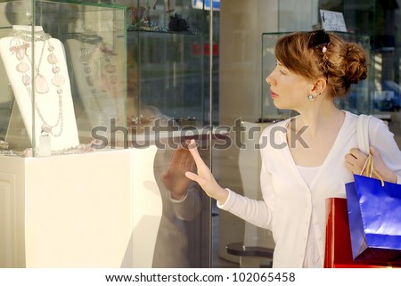 Woman looking into a shop window 1