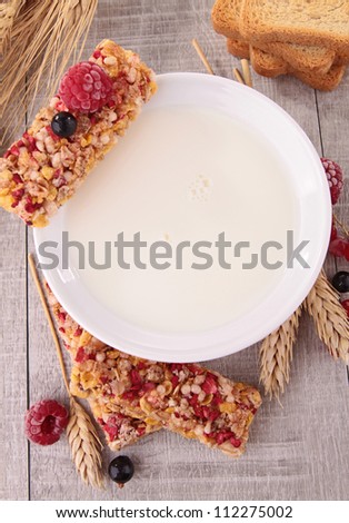 bowl of milk with granola and berries fruit