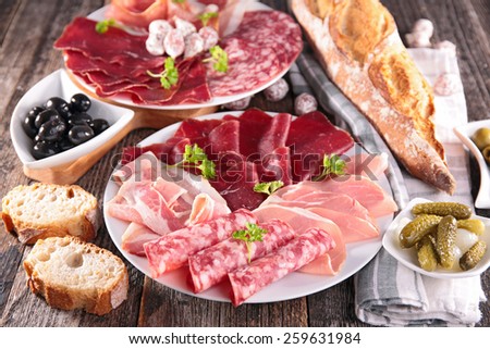 table with meat, bread, olive