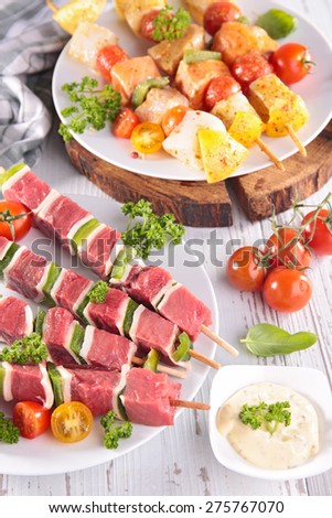 barbecue party with meat and fish kebab