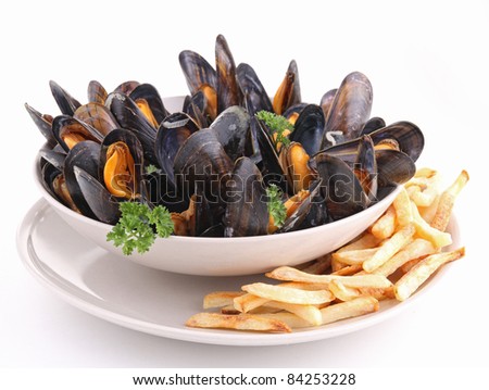 plate of mussels and french fries on white background